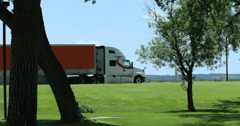 ELD mistakes illustrated by a commercial semi-truck traveling through a rural area, highlighting compliance risks fleets face when logs and electronic records are not properly managed.