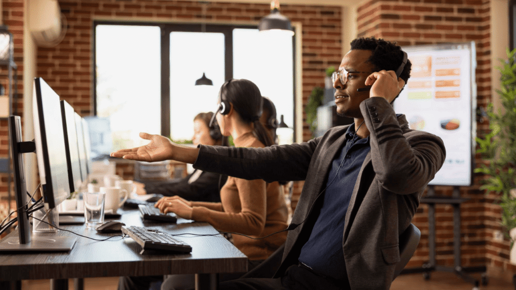 Customer service team working in a modern office supporting outsourcing trucking compliance services for transportation companies.